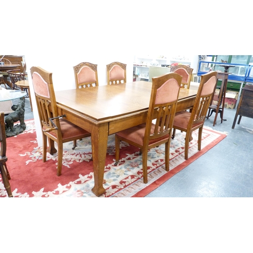 332 - Oak extending dining table and a set of six Art Nouveau-style oak dining chairs, with later upholste... 