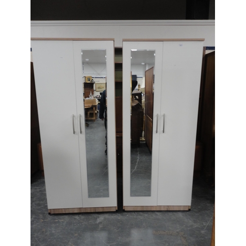 343 - Pair of contemporary white two-door wardrobes with mirrored panels.