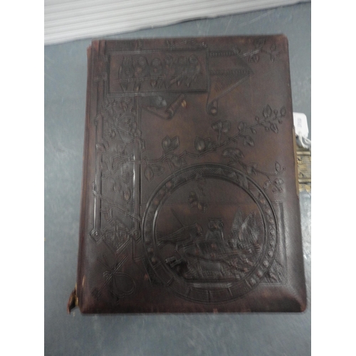 79 - Two Edwardian tooled photograph albums and contents.