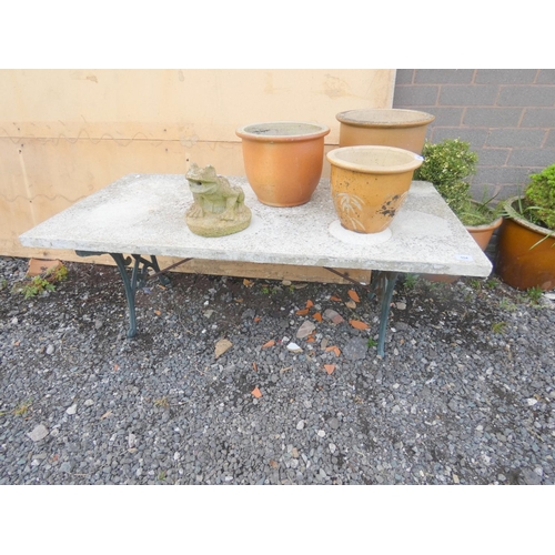 554 - Cast iron and concrete garden table.