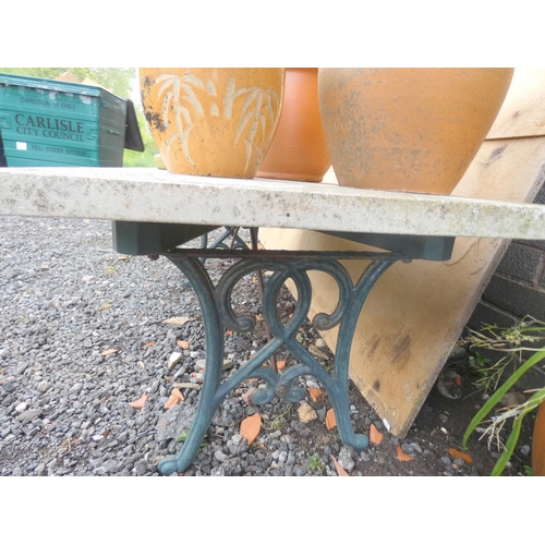 554 - Cast iron and concrete garden table.