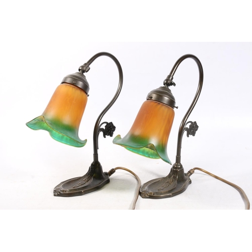 68 - Pair of Tiffany style wall lights, the frilly rim shades amber coloured with green border. (2)