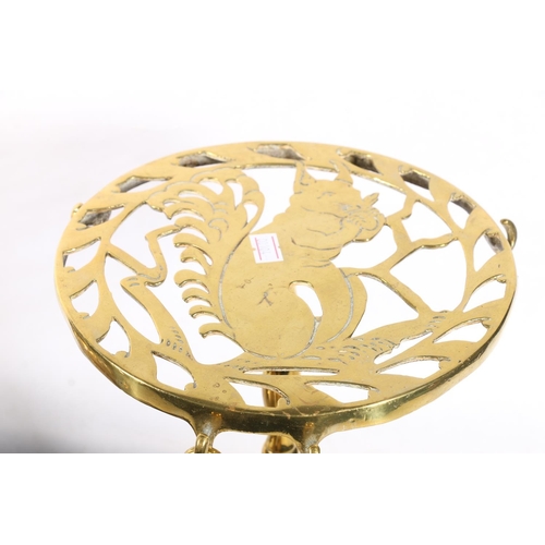 73 - Brass trivet, the circular pierced top decorated with profile of a squirrel, on knopped stem and tri... 