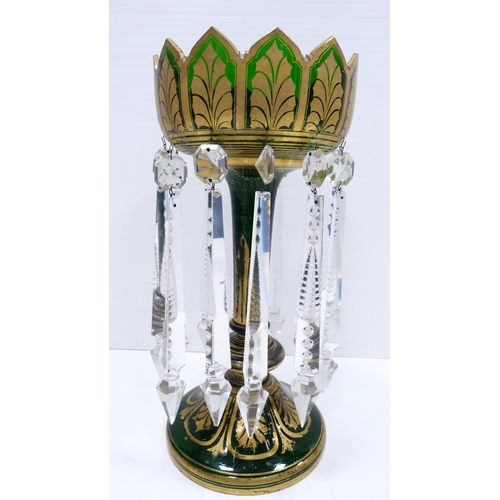 258 - Victorian green glass table lustre of large form decorated all over with gilded leaf vignettes and f... 