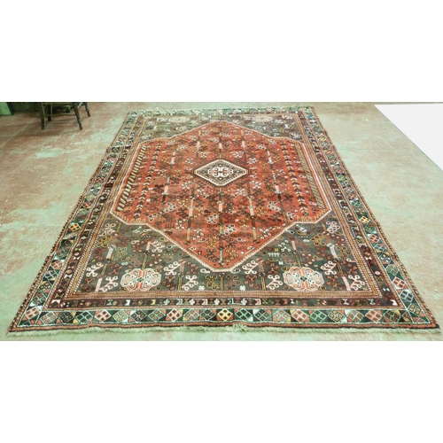 385 - Persian Shiraz hand-knotted rug decorated all over with geometric medallions, motifs and guls on a b... 