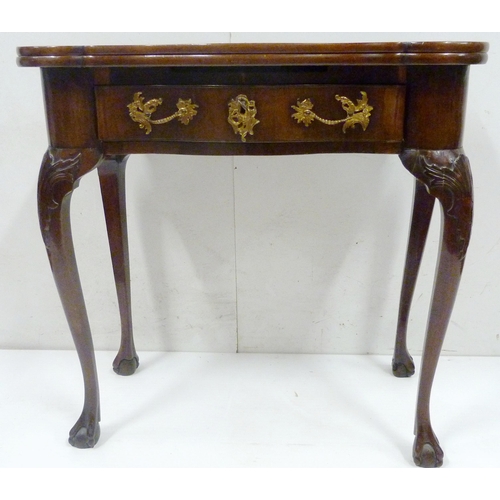 412 - George II style mahogany fold-over card table, on twin gate supports with central drawer, on ball an... 