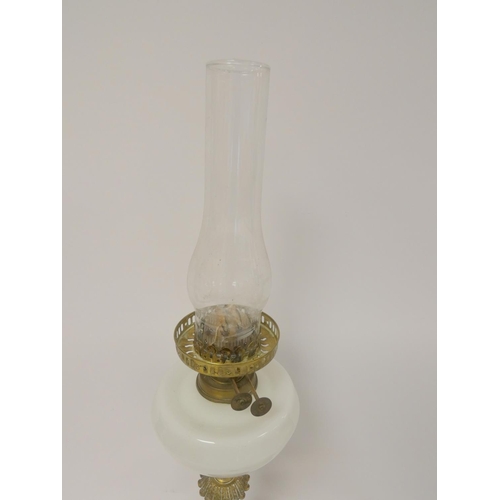 327 - Antique brass duplex oil lamp, stamped to the wick, with opaque glass reservoir and shade, with late... 