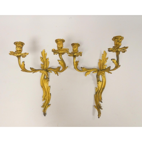 331 - Pair of Italian style gilt metal twin wall sconces, with all over Rococo influence, 39cm high. (2)