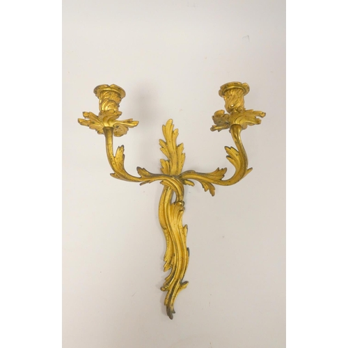 331 - Pair of Italian style gilt metal twin wall sconces, with all over Rococo influence, 39cm high. (2)