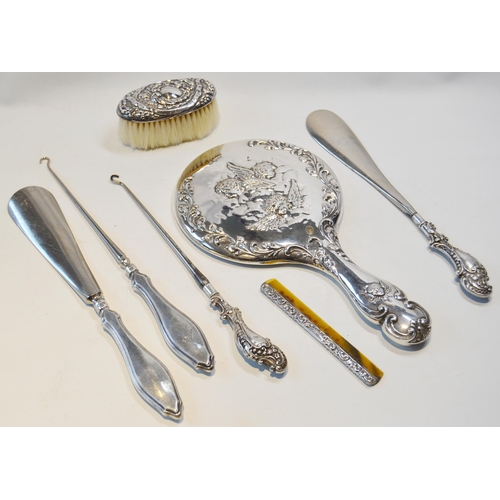 3 - Silver-mounted and embossed toilet mirror and six similar silver-mounted items.