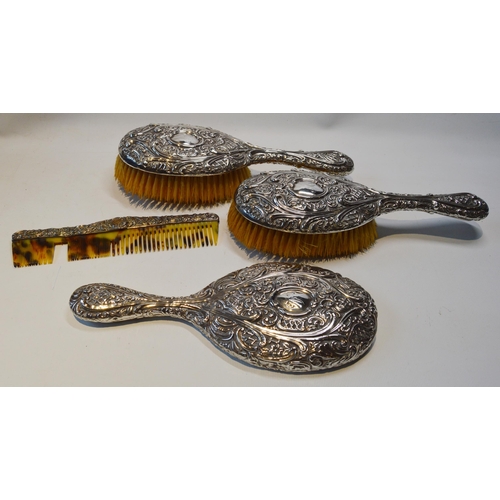 8 - Embossed silver four-piece toilet set of two brushes, a comb and a mirror, Birmingham 1893, cased.