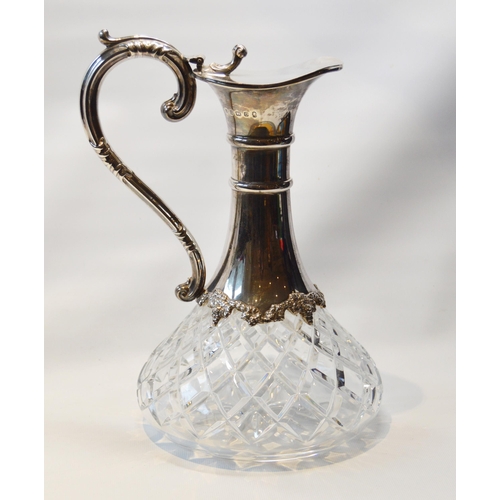 28 - Silver cut glass claret jug with ringed mount and scroll handle, 1977.