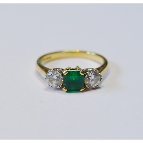 107 - Diamond and emerald three-stone ring, the brilliants approximately .3ct each, total diamond content ... 