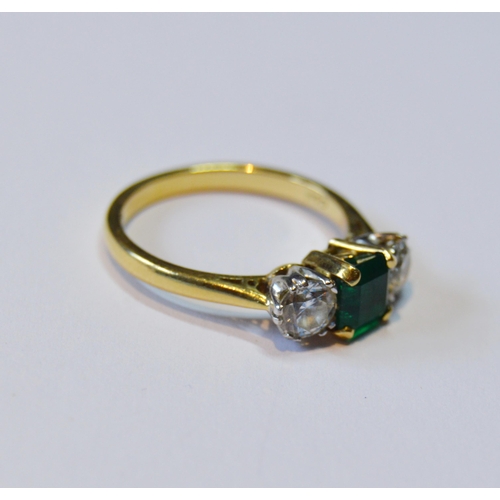 107 - Diamond and emerald three-stone ring, the brilliants approximately .3ct each, total diamond content ... 