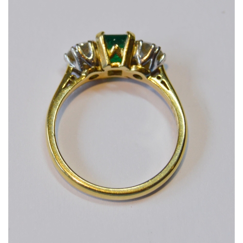 107 - Diamond and emerald three-stone ring, the brilliants approximately .3ct each, total diamond content ... 