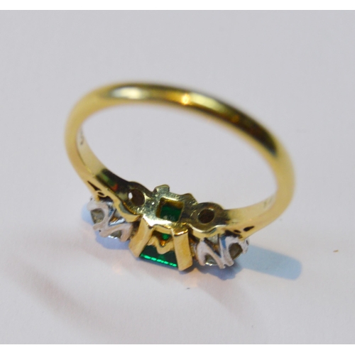 107 - Diamond and emerald three-stone ring, the brilliants approximately .3ct each, total diamond content ... 