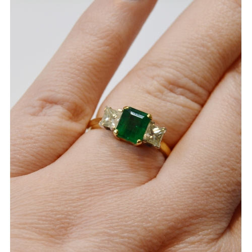 108 - Diamond and emerald three stone ring set with princess-cut brilliants, with a larger cut emerald to ... 