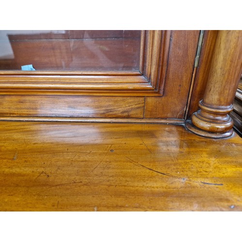 542 - Victorian mahogany glazed four door bookcase over cupboard.270cm high 54cm depth 280cm long