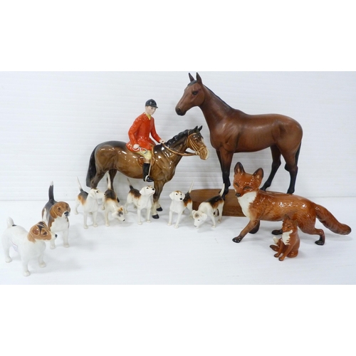 231 - Beswick porcelain hunting group comprising a huntsman on horseback, five hounds and a seated fox, al... 