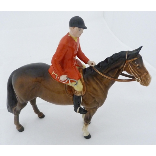 231 - Beswick porcelain hunting group comprising a huntsman on horseback, five hounds and a seated fox, al... 