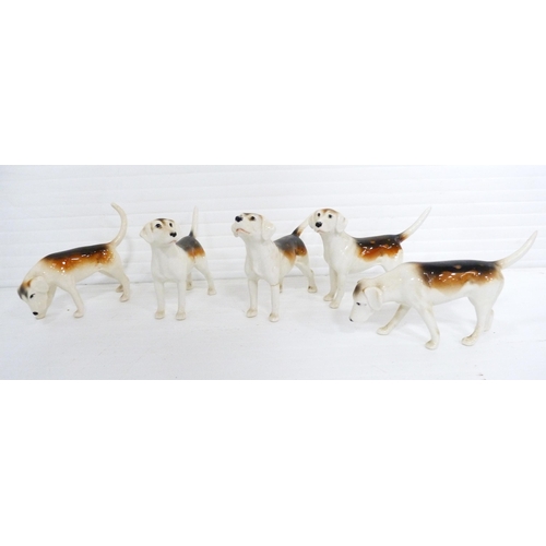 231 - Beswick porcelain hunting group comprising a huntsman on horseback, five hounds and a seated fox, al... 