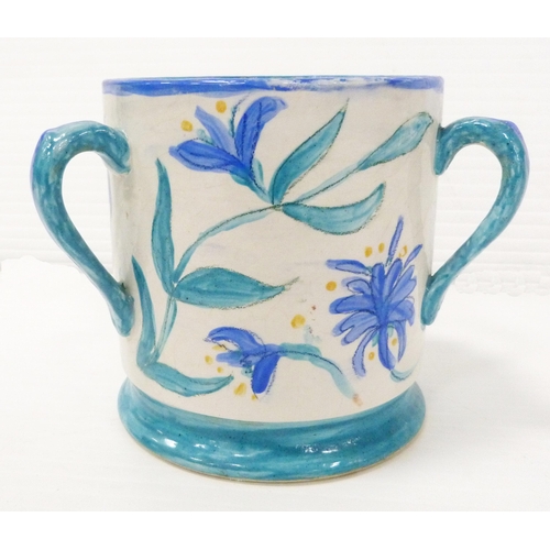 235 - Art pottery tyg hand-painted with floral motifs on a white field, glazed in a pale blue to handle, b... 