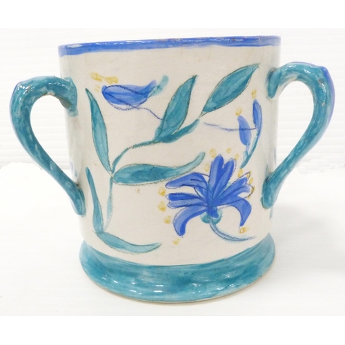 235 - Art pottery tyg hand-painted with floral motifs on a white field, glazed in a pale blue to handle, b... 