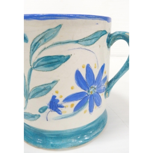 235 - Art pottery tyg hand-painted with floral motifs on a white field, glazed in a pale blue to handle, b... 