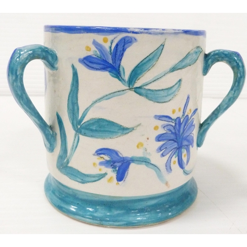 235 - Art pottery tyg hand-painted with floral motifs on a white field, glazed in a pale blue to handle, b... 