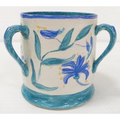 235 - Art pottery tyg hand-painted with floral motifs on a white field, glazed in a pale blue to handle, b... 