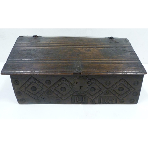 427 - 17th century oak bible box, the sloped top with iron mounts and lock, incised concentric roundels to... 