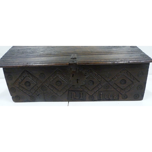 427 - 17th century oak bible box, the sloped top with iron mounts and lock, incised concentric roundels to... 