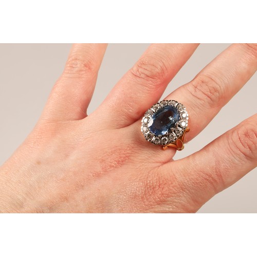 61 - Ladies blue topaz and diamond ring, Central stone surrounded by fourteen brilliant cut 0.1 carat dia... 