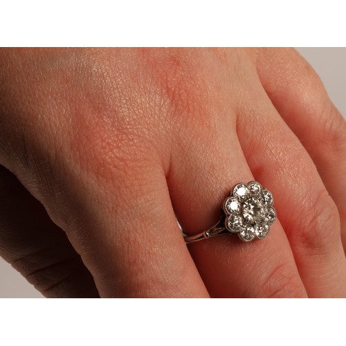 65 - Ladies Diamond daisy cluster ring set in white metal, central stone 0.5 carat surrounded by eight 0.... 