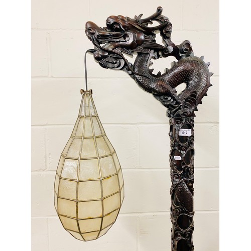 512 - Oriental style carved hardwood free standing lamp in the form of a dragon, with droplet leaded lamp,... 