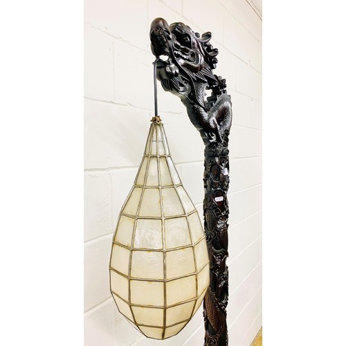 512 - Oriental style carved hardwood free standing lamp in the form of a dragon, with droplet leaded lamp,... 