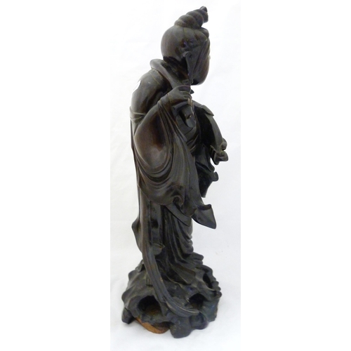 275 - Chinese carved hardwood sculpture, modelled as the goddess Guanyin holding a ruyi sceptre, fixed to ... 