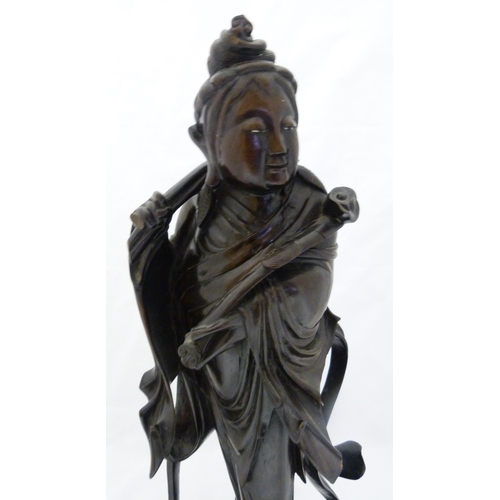 275 - Chinese carved hardwood sculpture, modelled as the goddess Guanyin holding a ruyi sceptre, fixed to ... 