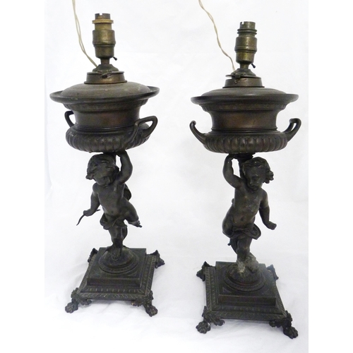 209 - Pair of Victorian Patent spelter urns, converted to table lamps, each raised aloft by a classical pu... 