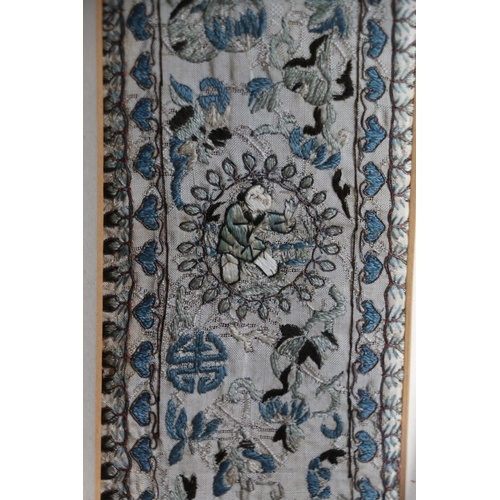 473 - Chinese embroidered needlework sleeve panel, frame size 62cm x 15cm.