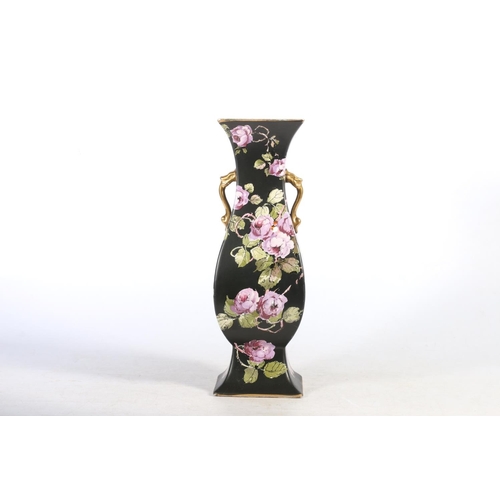 102 - Late Victorian Phoenix ware black pottery vase decorated with purple flowers.