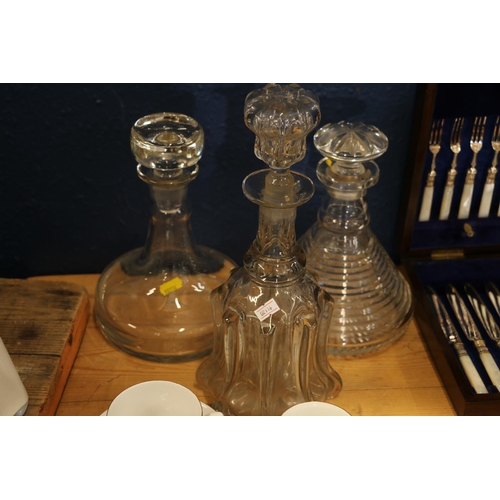 104 - Victorian mallet shaped glass decanter, a ribbed glass decanter and a ships decanter.