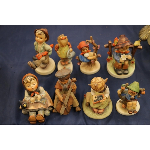 159 - Seven Hummel figurines and a German carved wooden figurine.