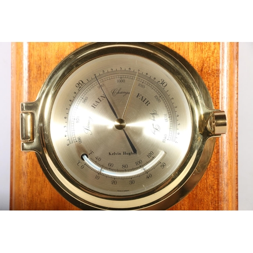 16 - Kelvin Hughes brass on wood bulkhead clock.