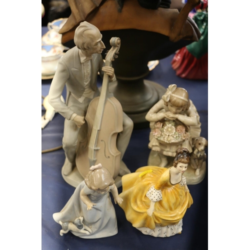 162 - Lladro Gres musician figurine, a Lladro figurine, a Nao figurine and a Royal Doulton figurine.