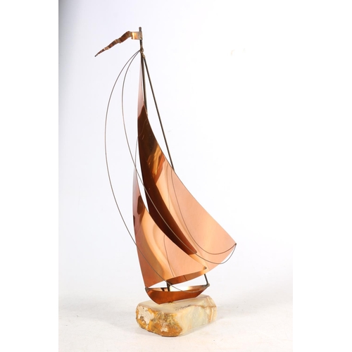 18 - Modernist brass model of a yacht on onyx base, signed to base.