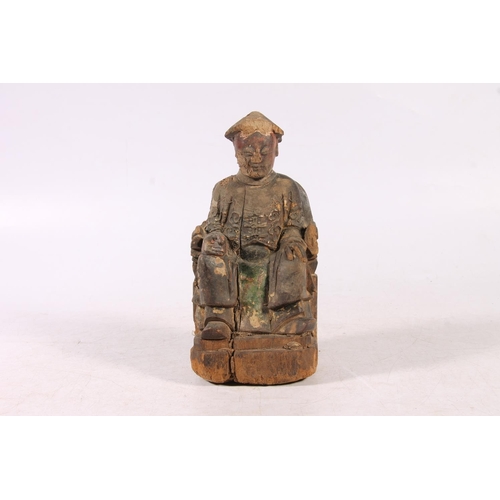 212 - Antique Chinese carved wooden figurine of gentleman seated, 21cm high.