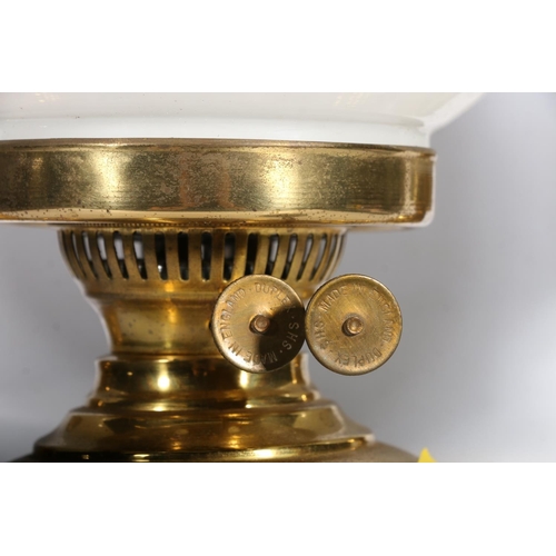 36 - Three brass oil lamps with globe glass shades.