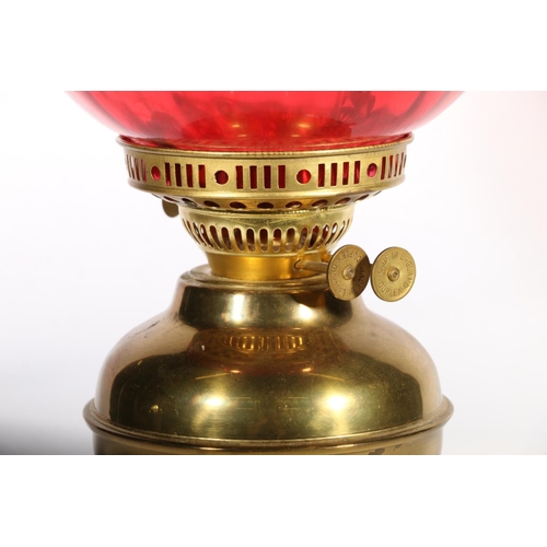 39 - Brass oil lamp with ruby red glass shade.