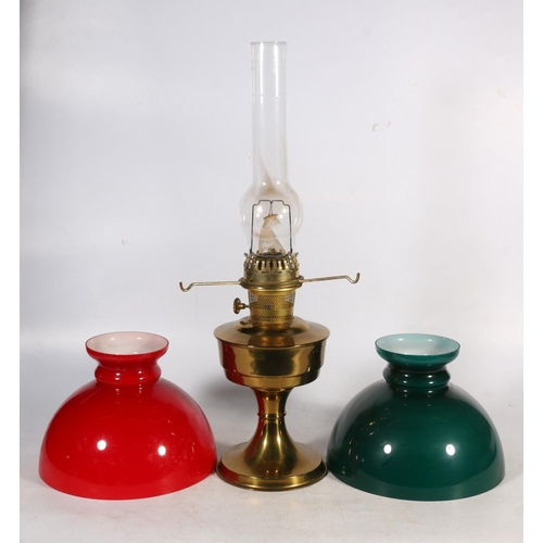 44 - Brass oil lamp with red glass shade, and a green glass shade.